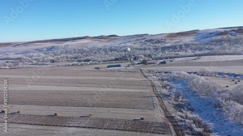 Aerial view of a misty countryside village, nature covered with hoarfrost