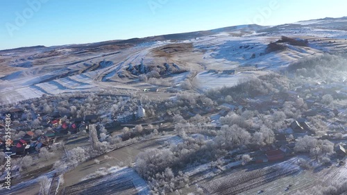 Aerial view of a misty countryside village, nature covered with hoarfrost