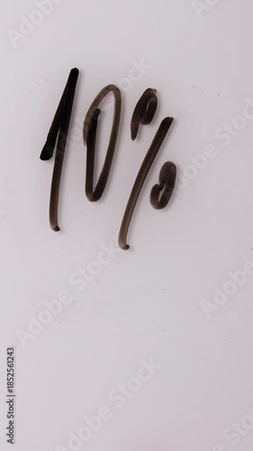 A hand writes percentages on a white board to show sales offers. The percentages are then erased and new percentages are written to reflect new deals.