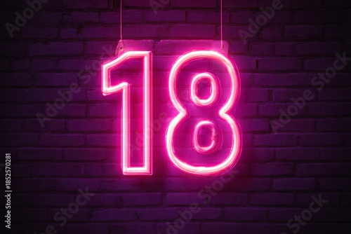 Neon Pink Number 18 Light Sign Against Dark Brick Wall Background