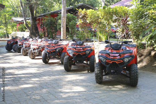 Foto Exciting row of powerful red ATV quad bike vehicle ready for fun adventure trave