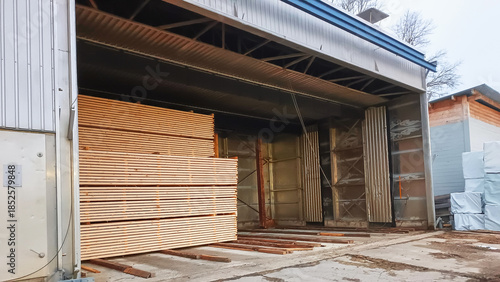 Lumber is stacked next to the drying chamber.
