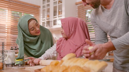 Happy Muslim family baking bakery together in kitchen at cozy home. 