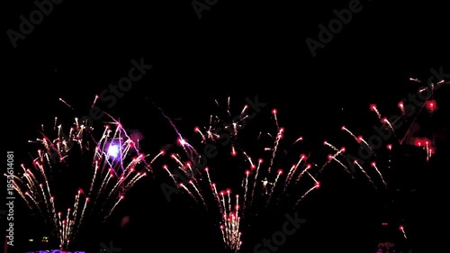 4K. loop seamless of real fireworks background golden shining fireworks with bokeh lights in the night sky. glowing fireworks show. New year's eve fireworks celebration multiple colors