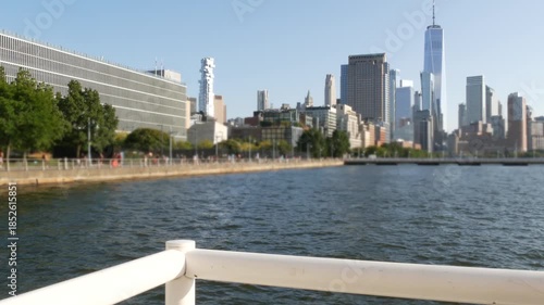 New York City Manhattan downtown financial district skyline, United States. Urban waterfront cityscape with skyscraper buildings, World Trade Center tower from Hudson River Park, riverfront promenade.