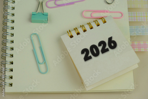 word 2026 on green calendar nearby colorful office tools as a 2026 calendar concept