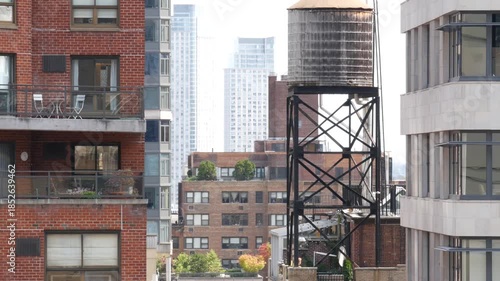 New York City Midtown East urban residential buildings, red brown brick architecture, Manhattan rooftop, United States of America. Water towers on roof. Cityscape with classic water tanks, Turtle Bay.
