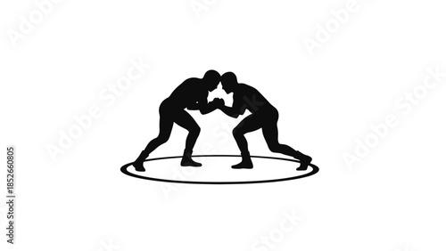 Two wrestlers in intense competition on circular mat