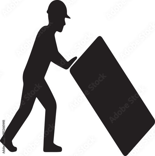 Construction worker pushing heavy object on construction site silhouette during day time