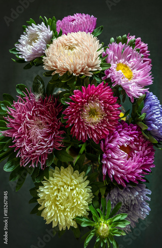 Still life with a close-up of a bouquet of beautiful multi-colored dahlias.