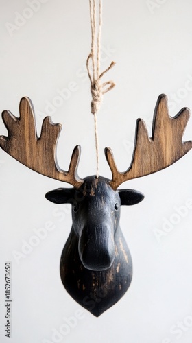 Hanging wooden moose head ornament with rustic antlers on rope