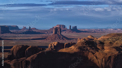 Aerial view of majestic sandstone buttes piercing the horizon under a vast sky, Monument Valley, Arizona, United States.