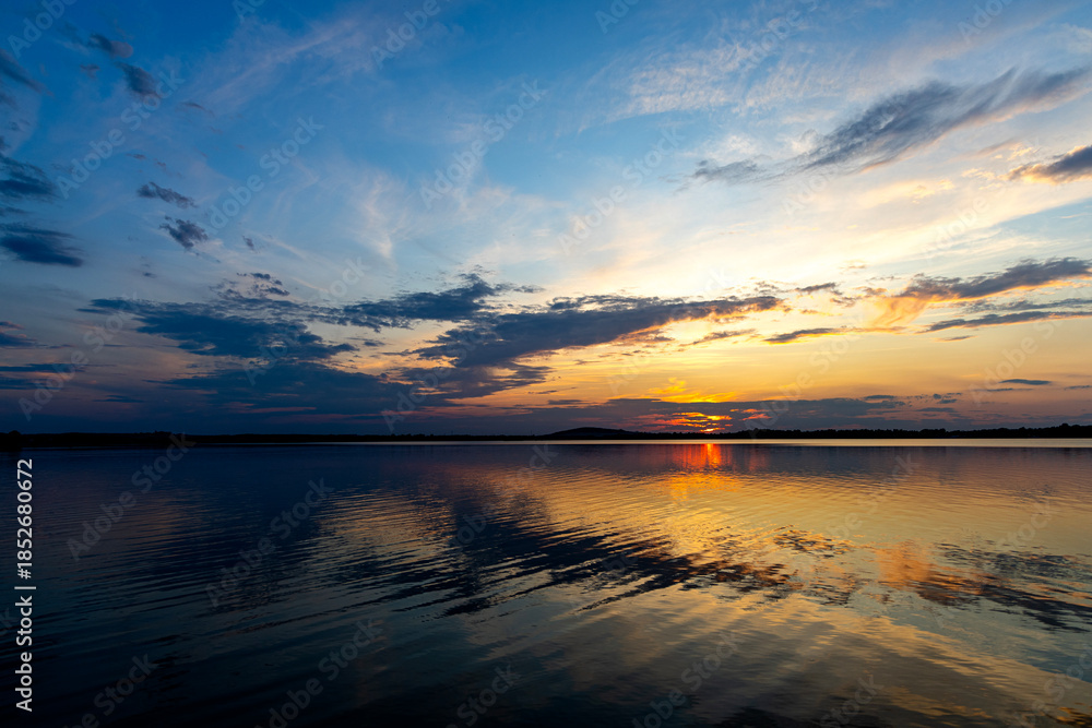 Obraz premium Dramatic summer sunset over Lake Mitkow in Poland. Evening landscape.