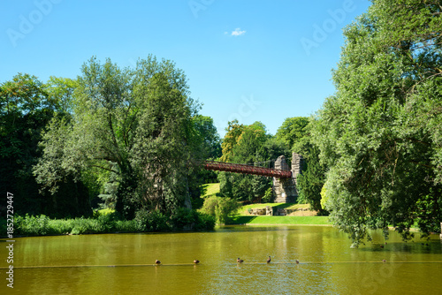Suspended footbridge over the lake in the Buttes-Chaumont park 19th arrondissement of Paris city
