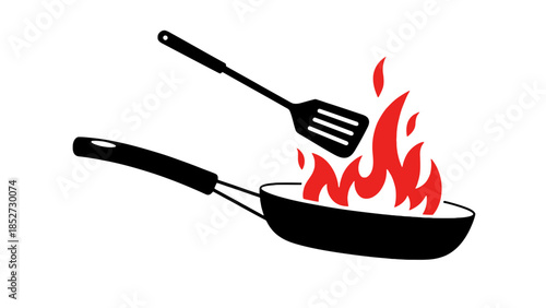 A spatula is used to flip food in a frying pan with flames.