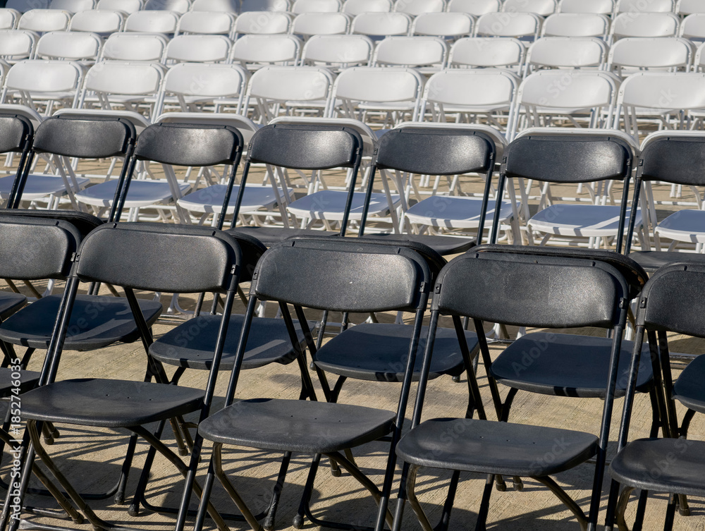 Fototapeta premium Outdoor rows of folding chairs set up for an event