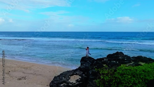 Serene Woman on a Rocky Tropical Shore	