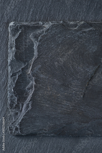Close-up shot of two different grey stone textures with varying degrees of roughness and layering. The stone has a layered texture. Background texture or design element.