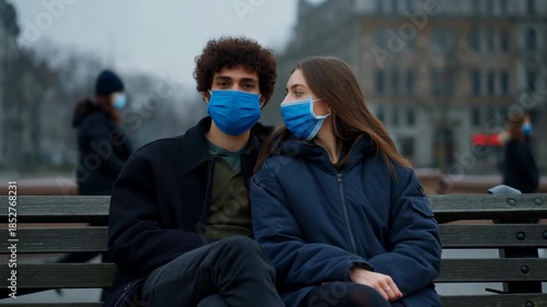 Couple Sitting Quietly With Masks, Intimate Moment Between Individuals Wearing Masks In Urban Setting