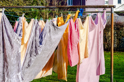 Wallpaper Mural Colorful laundry drying on a clothesline in the bright sunshine on a green lawn Torontodigital.ca