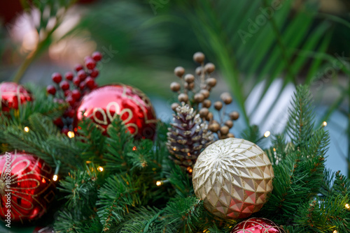 Christmas ornaments and pine cones arranged on greenery.