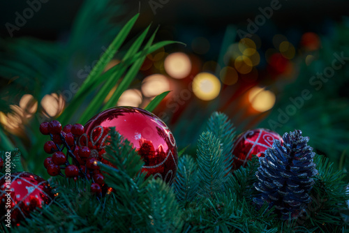 Christmas ornaments and pine cones arranged on greenery.