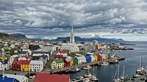 Colorful townscape of seydisfjordur, iceland, with a prominent church and snowcapped mountains