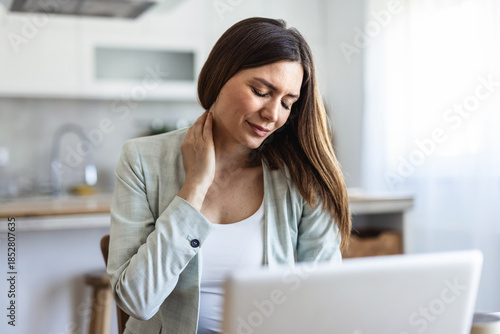 Woman, neck pain and stress with injury for overworked pressure, fatigue or strain in home. Female person, freelancer or remote work with sore shoulder or muscle tension for project deadline in house.