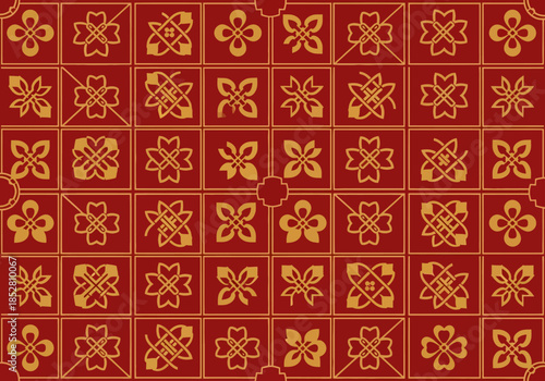 Close-up of a red and gold patterned tile design with floral motifs.