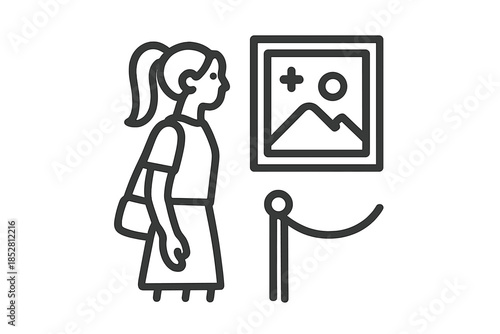 Woman looking at framed painting in museum