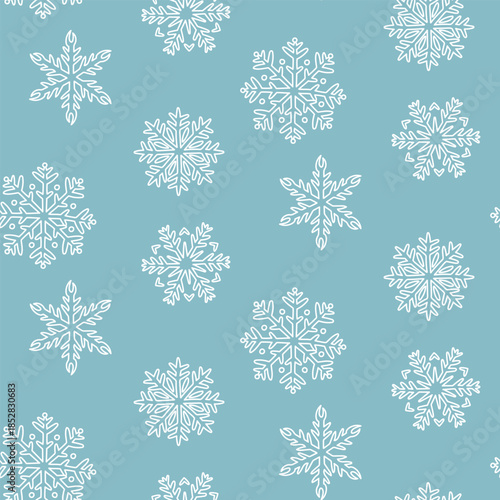 Seamless pattern with white doodle snowflakes of various shapes on blue. Minimalist winter design for wrapping paper, Christmas gifts, seasonal textile prints, or festive digital images.