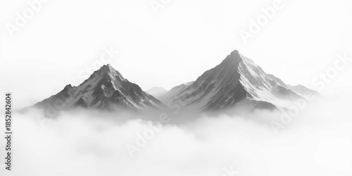 Two rugged mountain peaks rising above fog or mist