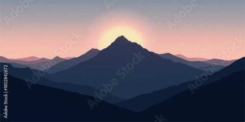 Sunrise over rugged mountain range with peak in center