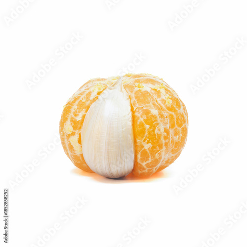 Peeled tangerine with garlic clove on white background