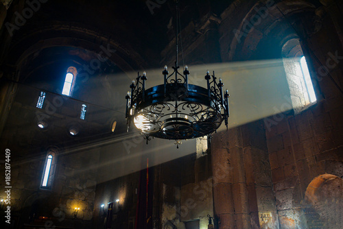 Monastery interior. An old lamp in the church. Sunlight streaming through the windows. Christianity and religion.