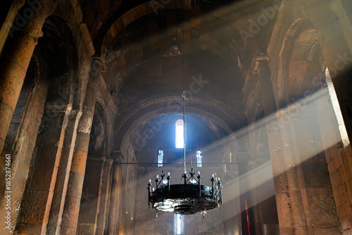 Monastery interior. An old lamp in the church. Sunlight streaming through the windows. Christianity and religion.