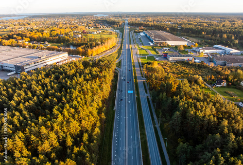 Canvas Print Aerial view of divided highway with warehouses and loading bays