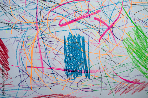 A paper covered with a chaotic mixture of blue, green and red scribbles.
