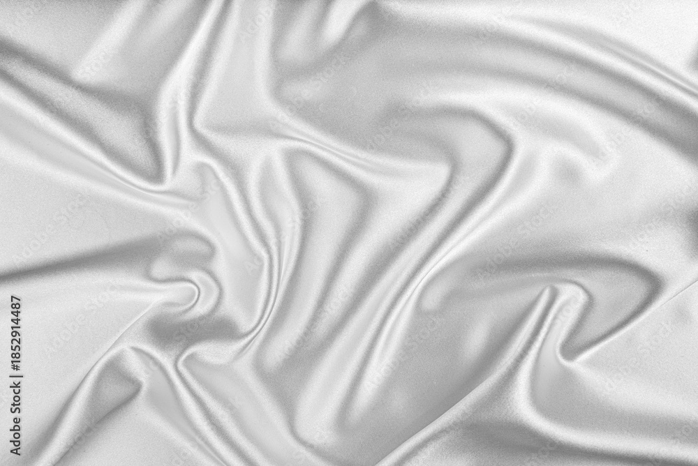 Fototapeta premium Elegant white silk fabric is draped in a circular ripple pattern.