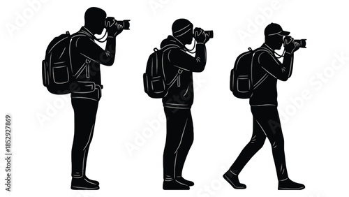 Three photographers with backpacks taking pictures in silhouette