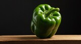 Vibrant green bell pepper on a wooden surface