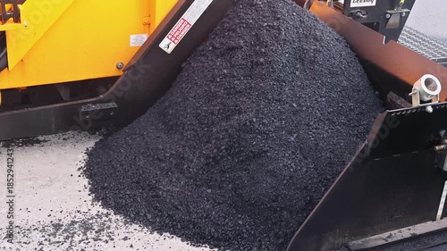 October 14 2025 New York USA Workers operate paving machine to lay new asphalt on construction road site