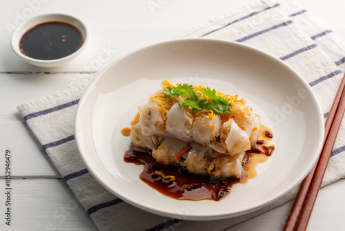 Chinese Steamed Rice Noodle Roll with shrimp and crispy tofu topped with sweet soybean vinaigrette.Thai snack food.(Kuay Thiao Lord)