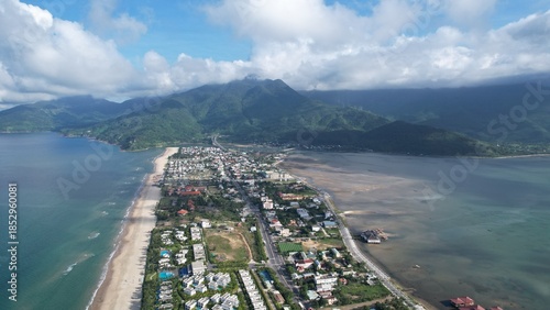 High-angle drone shot capturing Lang Co's unique strip of land separating the deep blue ocean from the tranquil lagoon.