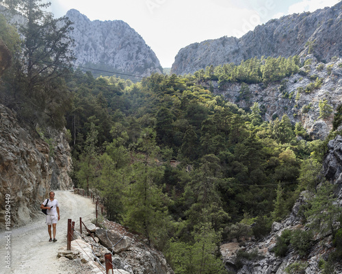 Path toward dramatic limestone mountains in Goynuk canyon, Turkey. Walk along rocky canyon road.