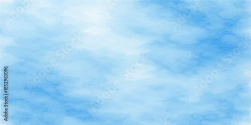 A beautiful clear blue sky filled with bright white fluffy clouds creates a natural summer cloudscape and a peaceful sunny atmosphere