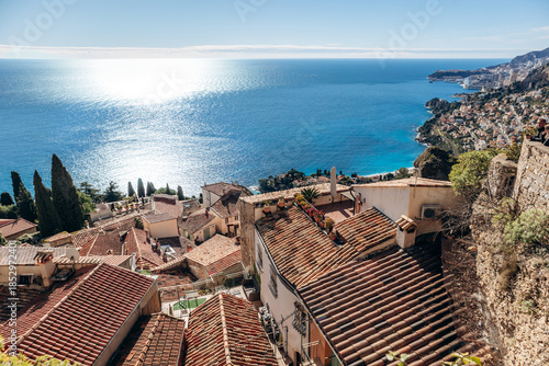 Panoramic view of the old village rooftops and Mediterranean Sea under a clear blue sky