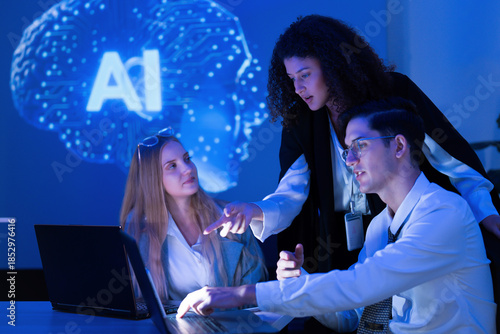 Team collaborates on artificial intelligence project in modern workspace with blue lighting