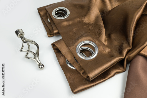 Metal eyelets on brown velvet curtains with a cage decoritive finial