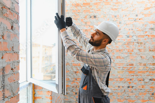 Slika na platnu Builder installing new window at construction site